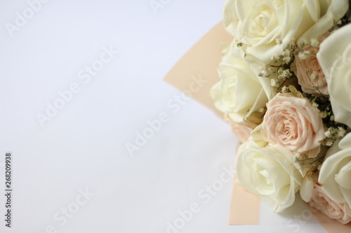 wedding bouquet of light pastel roses on a white background with a place for an inscription