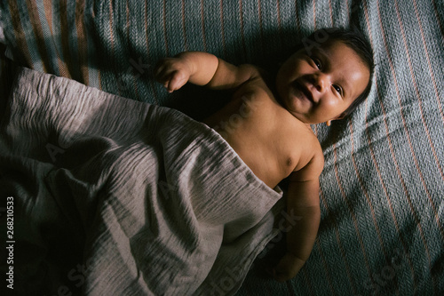 A Baby Lying in Beautiful Blankets photo