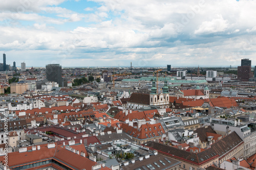 Wien, Austria. May, 2019. Panorama of the city from the observation tower of St. Stephen’s Cathedral. Roofs of houses. In the distance, the Alpine Mountains. Sky view.