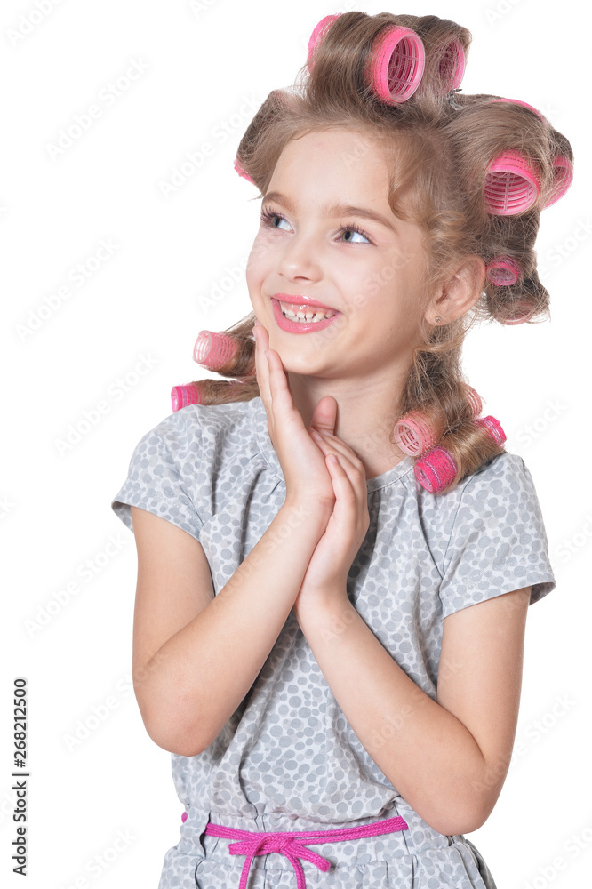 Happy little pretty girl with hair curlers in studio isolated on white background Happy little pretty girl with hair curlers in studio isolated on white background
