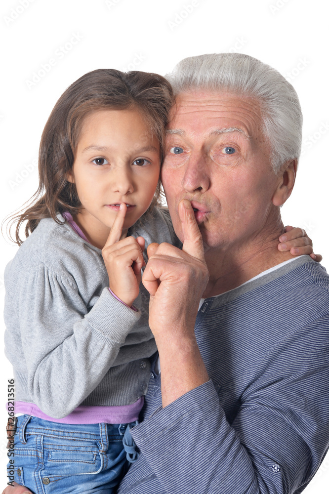 Senior man and little girl gesturing silence with finger on lips on white background Senior man and little girl gesturing silence with finger on lips on white background