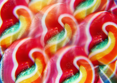 Close-up of swirly rainbow lollipop through prism filter photo