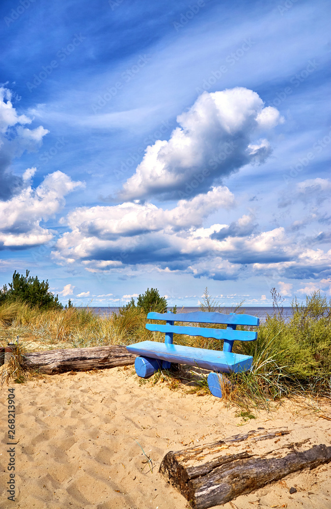 Blue bench on the cliff in Ückeritz on the beach. Baltic Sea in Mecklenburg-Vorpommern, Germany. - obrazy, fototapety, plakaty 