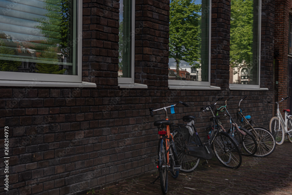 Group of bicycles parked near brick wall