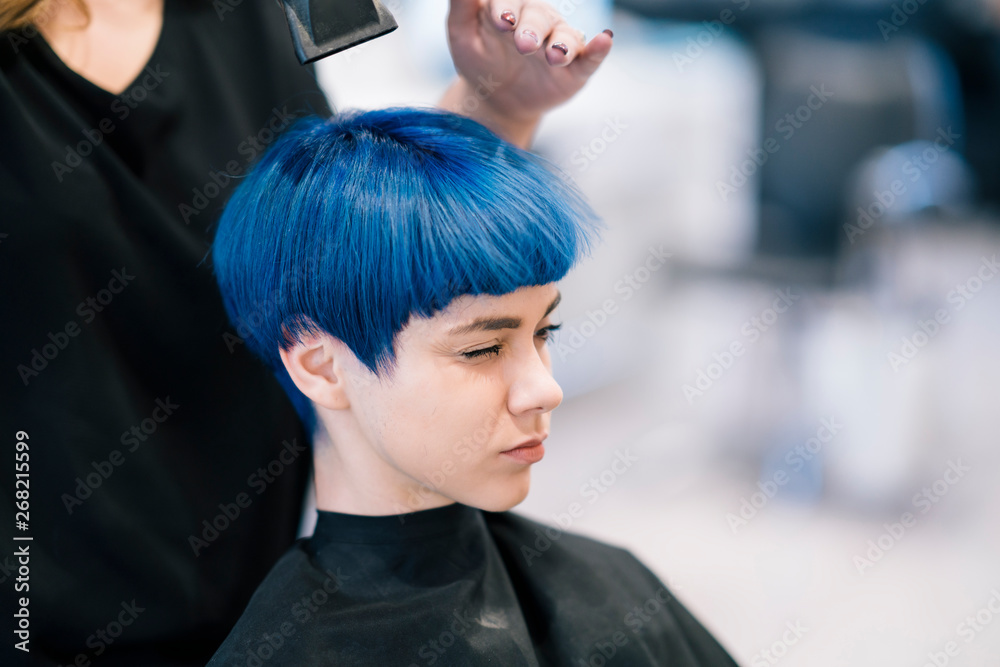 Young Woman dyeing her hair at a Salon Young Woman dyeing her hair at a Salon