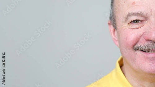 Half face of senior laughing man. Positive human facial emotion.