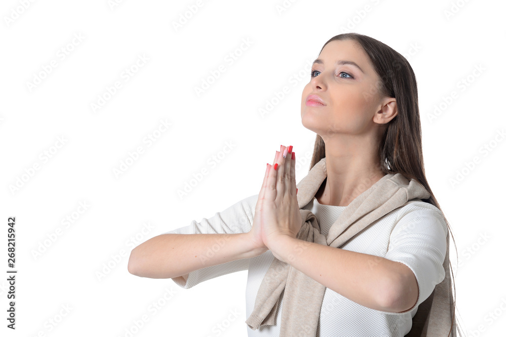Portrait of beautiful young woman praying on white background Portrait of beautiful young woman praying on white background
