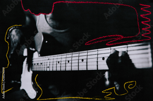 Low res mixed media print of a man playing electric guitar with chalk markings added photo