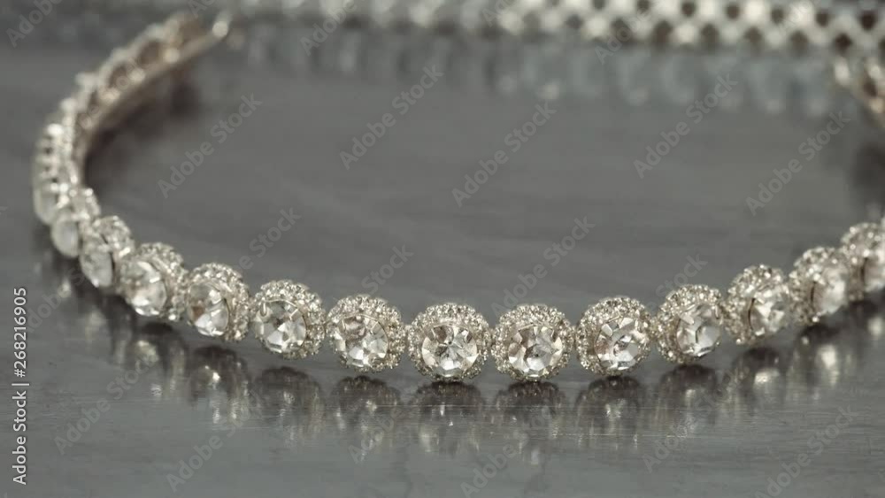 Close up of wreath of pearls spinning with metallic background