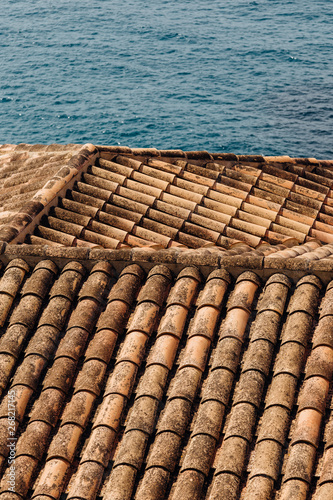 Abstract view of tile roof and sea