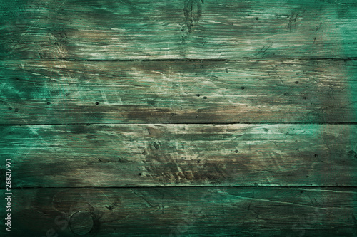 Old grunge rustic green brown dark scratched wood texture background. Text space, empty template.