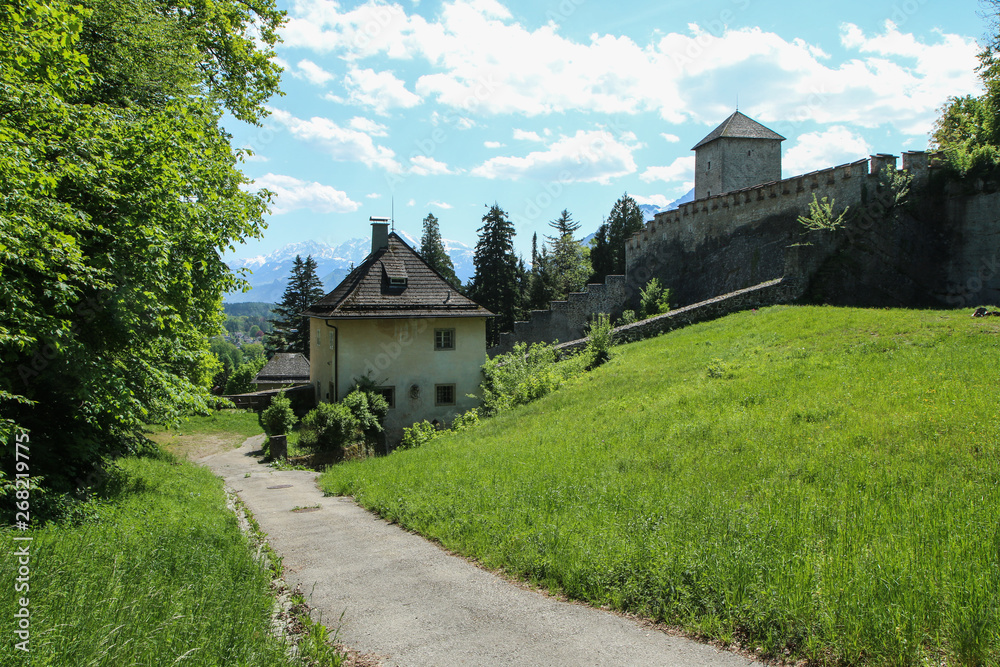 The old houses close to Salzburgs castle Hohensalzburg in Austria. You can see the countryside and the Alps behind.