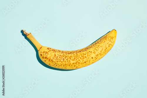 Ripe banana on blue table