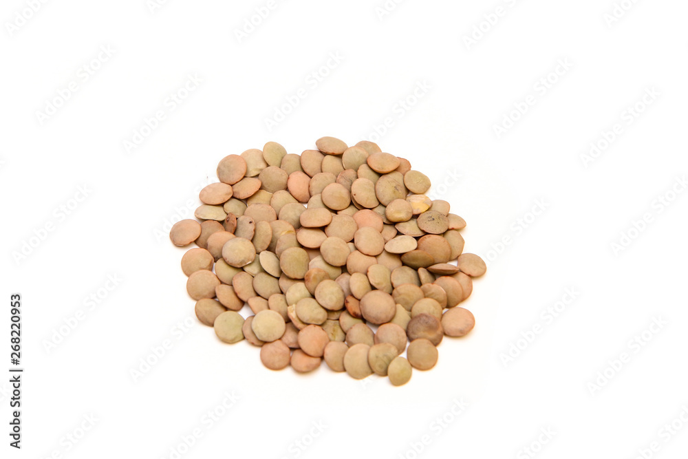 The small amount, a pile, of green lentils isolated on a white background. The small amount, a pile, of green lentils isolated on a white background.
