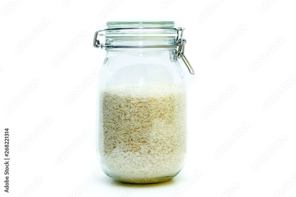 The rice stored inside the closable glass bottle isolated on a white background. The rice stored inside the closable glass bottle isolated on a white background.