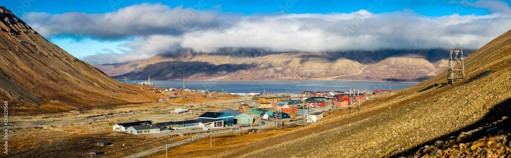 Hiking along the mountains - View over Longyearbyen and adventdalen fjord from above - the most Northern settlement in the world. Svalbard, Norway