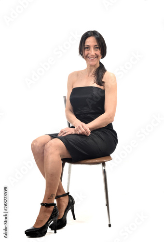woman with off shoulder dress sitting on a chair isolated on white © curto