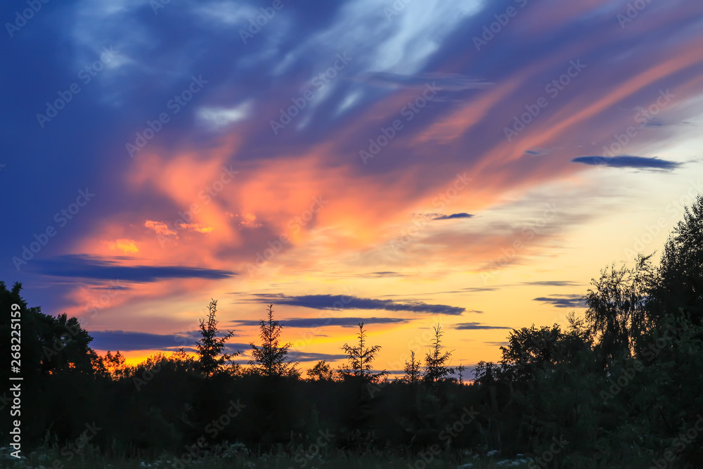 Beautiful cloudscape with blue sky and bright clouds at sunset in summer.