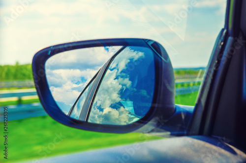 Landscape in the sideview mirror of a car