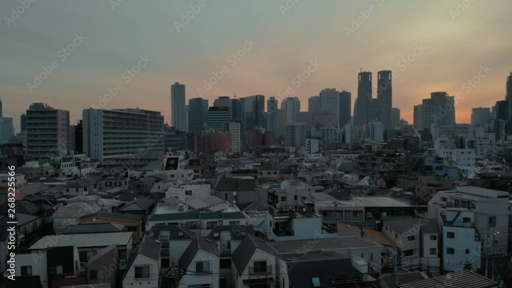 Low altitude ascending Aerial shot of Sunrise over Tokyo Honmachi - Shinjuku, Japan Low altitude ascending Aerial shot of Sunrise over Tokyo Honmachi - Shinjuku, Japan