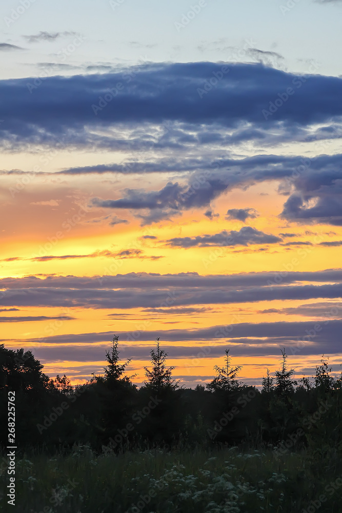 Beautiful cloudscape with blue sky and bright clouds at sunset in summer.