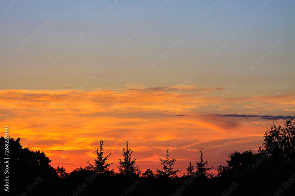 Beautiful cloudscape with blue sky and bright clouds at sunset in summer.
