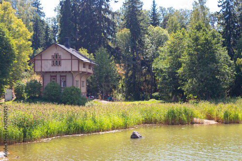 Seurasaari island beach with a wooden old forest hut in Helsinki in Finland on a sunny summer day