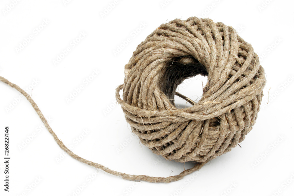 Ball of string linen twine at the white background