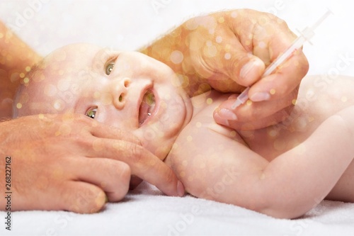 Doctor vaccinating baby isolated on a white