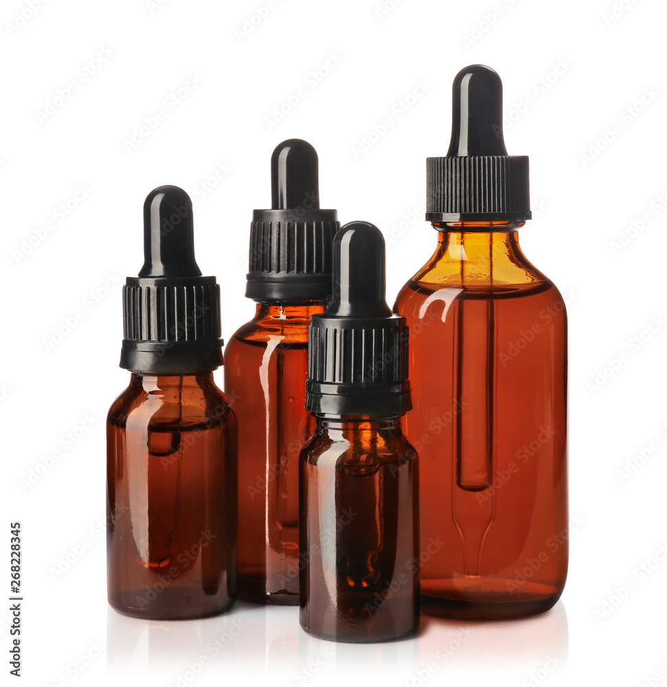 Cosmetic bottles of essential oils on white background Cosmetic bottles of essential oils on white background