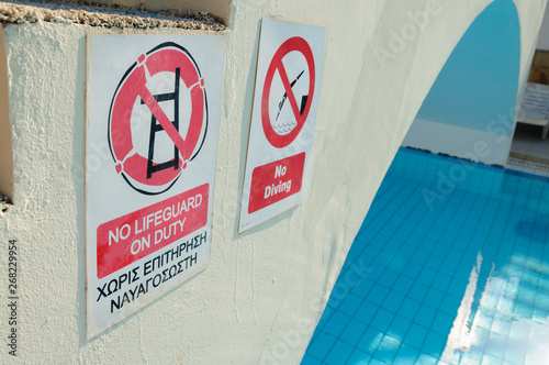 Signs by a swimming pool 