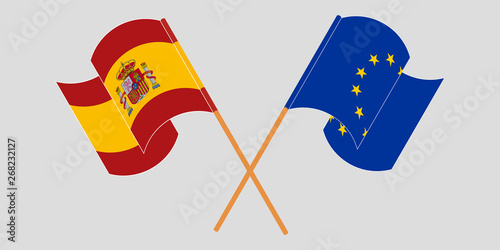 Crossed and waving flags of the EU and Spain