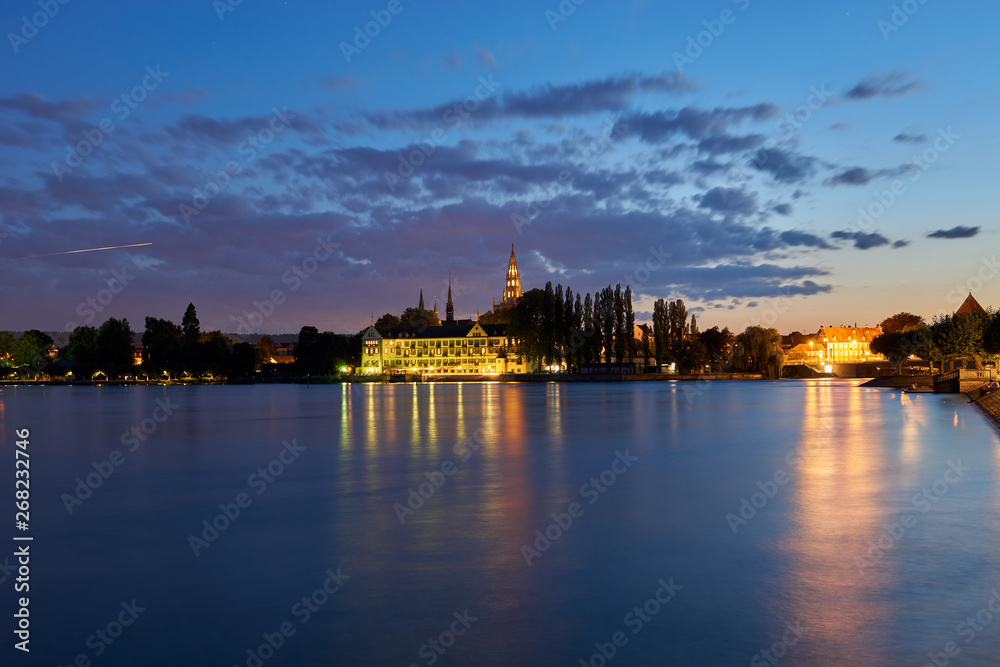 Lake of Constance at sunset blue hour, looking at the city, a hotel, the cathedral