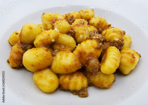 Close-up of potato gnocchi with bolognese sauce (ragu) on a white plate  © Claudio Caridi