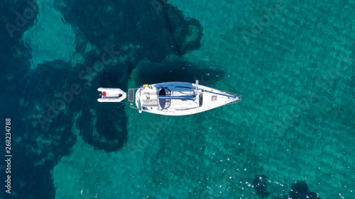 Fototapeta Naklejka Na Ścianę i Meble -  Aerial drone birds eye view of sail boat cruising in the emerald Ionian sea, Greece