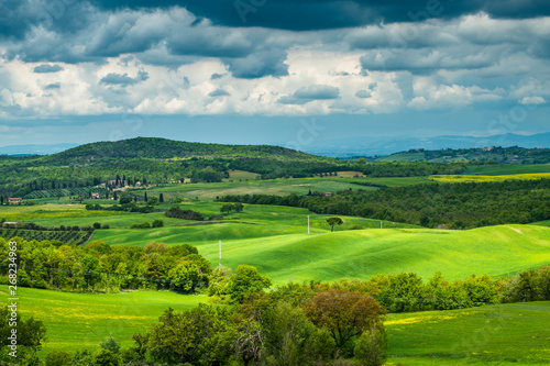 Tuscany spring  rolling hills and windmill on sunset. Rural landscape. Green fields. Italy  Europe