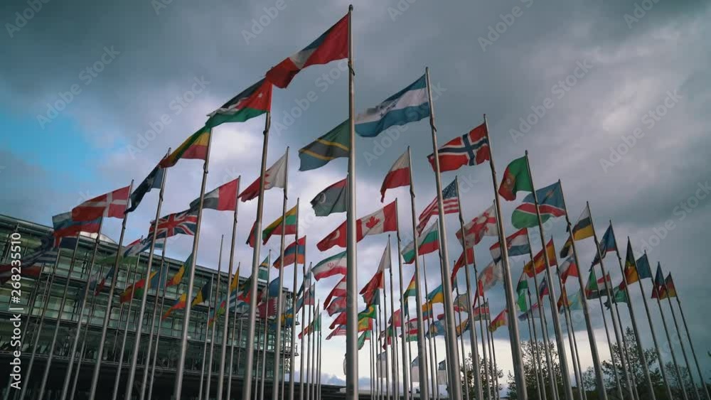 International flags of different countries waving in the wind on flagpoles - Ukrainian, Norway, Poland, Canadian, Georgian, Armenian, Lithuanian, Austrian and more International flags of different countries waving in the wind on flagpoles - Ukrainian, Norway, Poland, Canadian, Georgian, Armenian, Lithuanian, Austrian and more