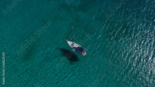 Aerial drone birds eye view of sail boat cruising in the emerald Ionian sea, Greece