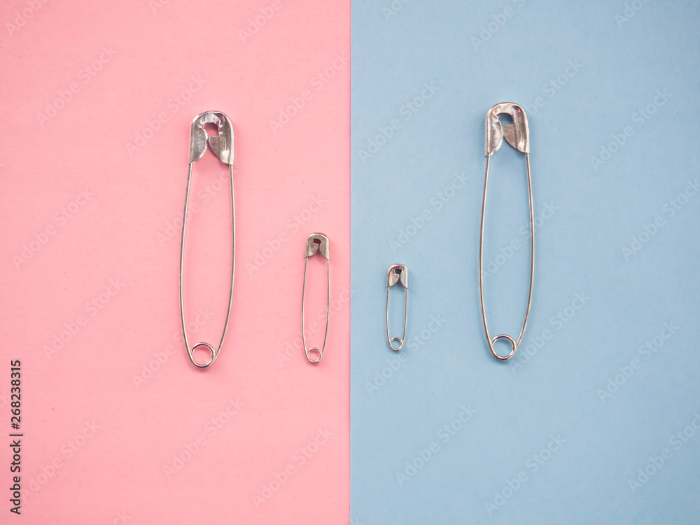 Several safety pins of various sizes in human representation. Concept of traditional family with children Several safety pins of various sizes in human representation. Concept of traditional family with children
