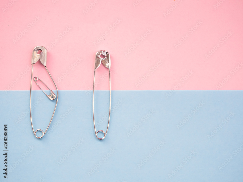 Several safety pins of various sizes in human representation. Concept of traditional family with children Several safety pins of various sizes in human representation. Concept of traditional family with children
