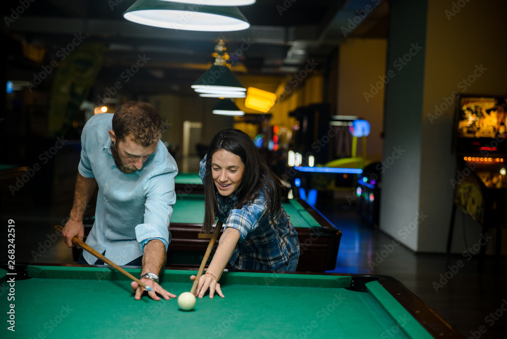 Fototapeta premium Happy couple playing snooker together