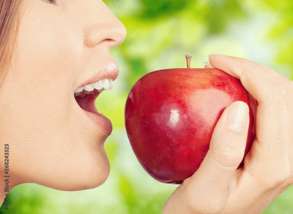 Young woman holding fresh apple on white background Young woman holding fresh apple on white background
