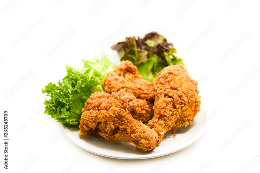 Fried chicken crispy on plate with salad lettuce on white Fried chicken crispy on plate with salad lettuce on white