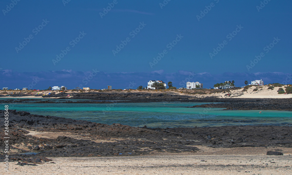 turquoise sea set among the black volcanic rock of Fuerteventura. Canary Islands - Spain