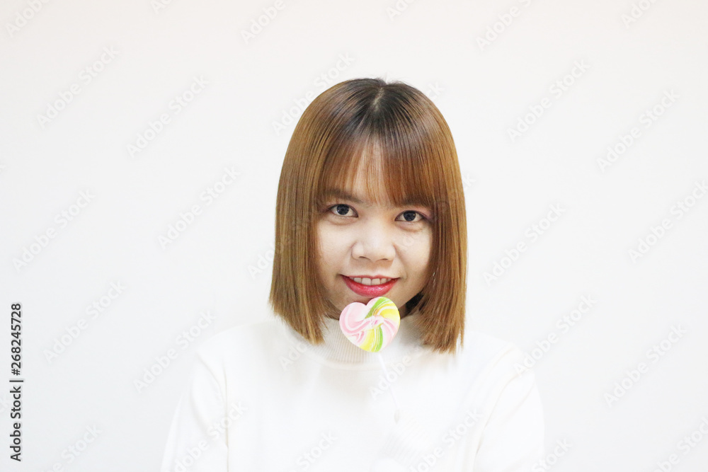 easterner asian girl eating colourful lollipop. easterner asian girl eating colourful lollipop.