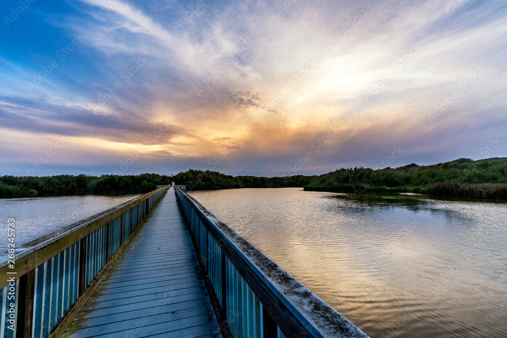 Boardwalk over Lake at Sunset