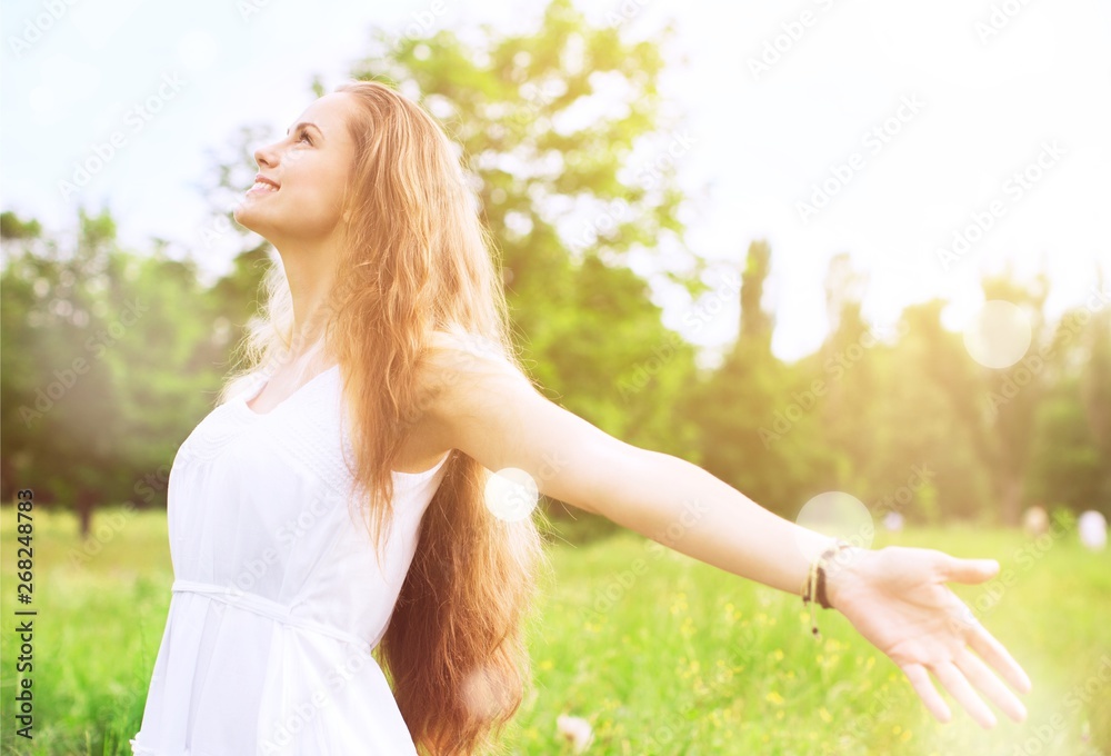 Happy woman with arms open on natural background Happy woman with arms open on natural background