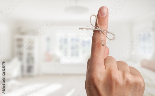 Rope bow on finger pointing  up on background photo