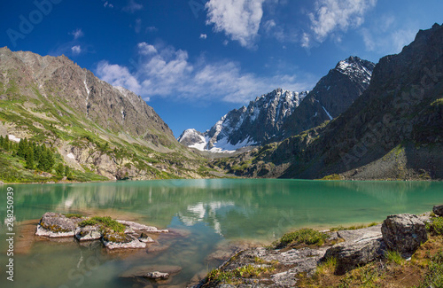 A picturesque lake in the mountains of Altai, travels in Russia. Summer vacation in the mountains.