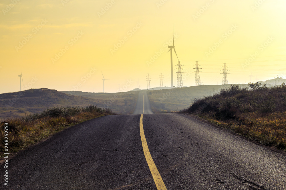 A windmill that generates electricity on the prairie A windmill that generates electricity on the prairie